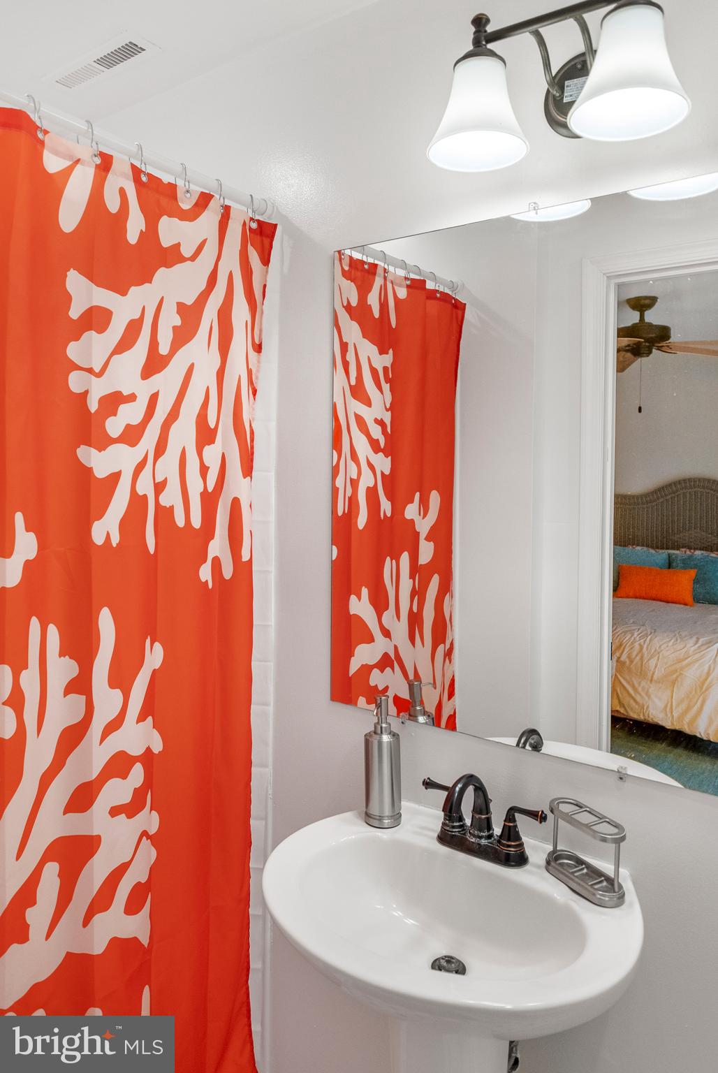 170 Captains Quarters Road, Unit 201 Ocean City, MD 21842 - Photo 48 of 65 a bathroom with a sink and a mirror