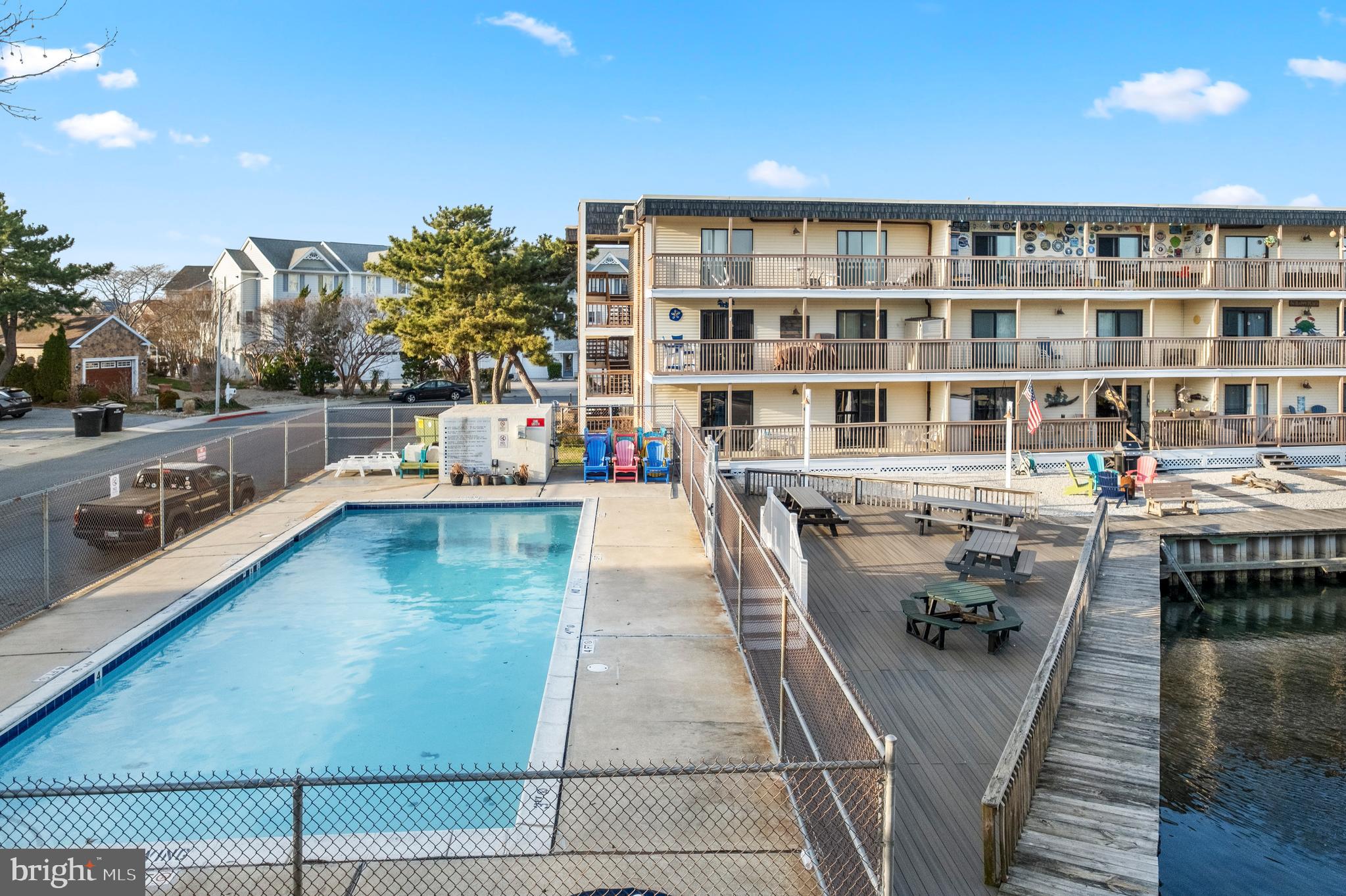 170 Captains Quarters Road, Unit 201 Ocean City, MD 21842 - Photo 53 of 65 a balcony with wooden floor and outdoor seating