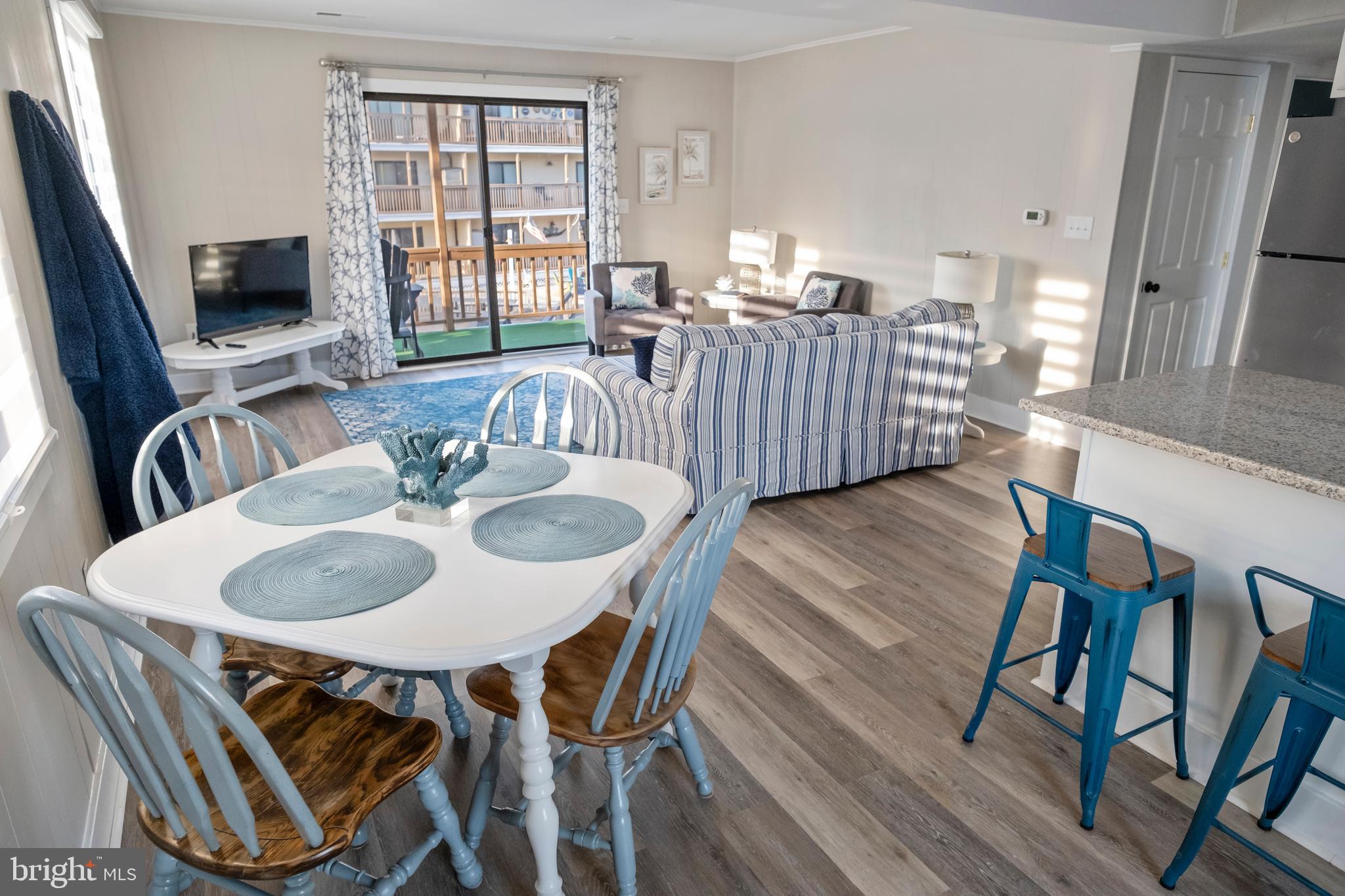 170 Captains Quarters Road, Unit 201 Ocean City, MD 21842 - Photo 55 of 65 a dining room with furniture a window and wooden floor