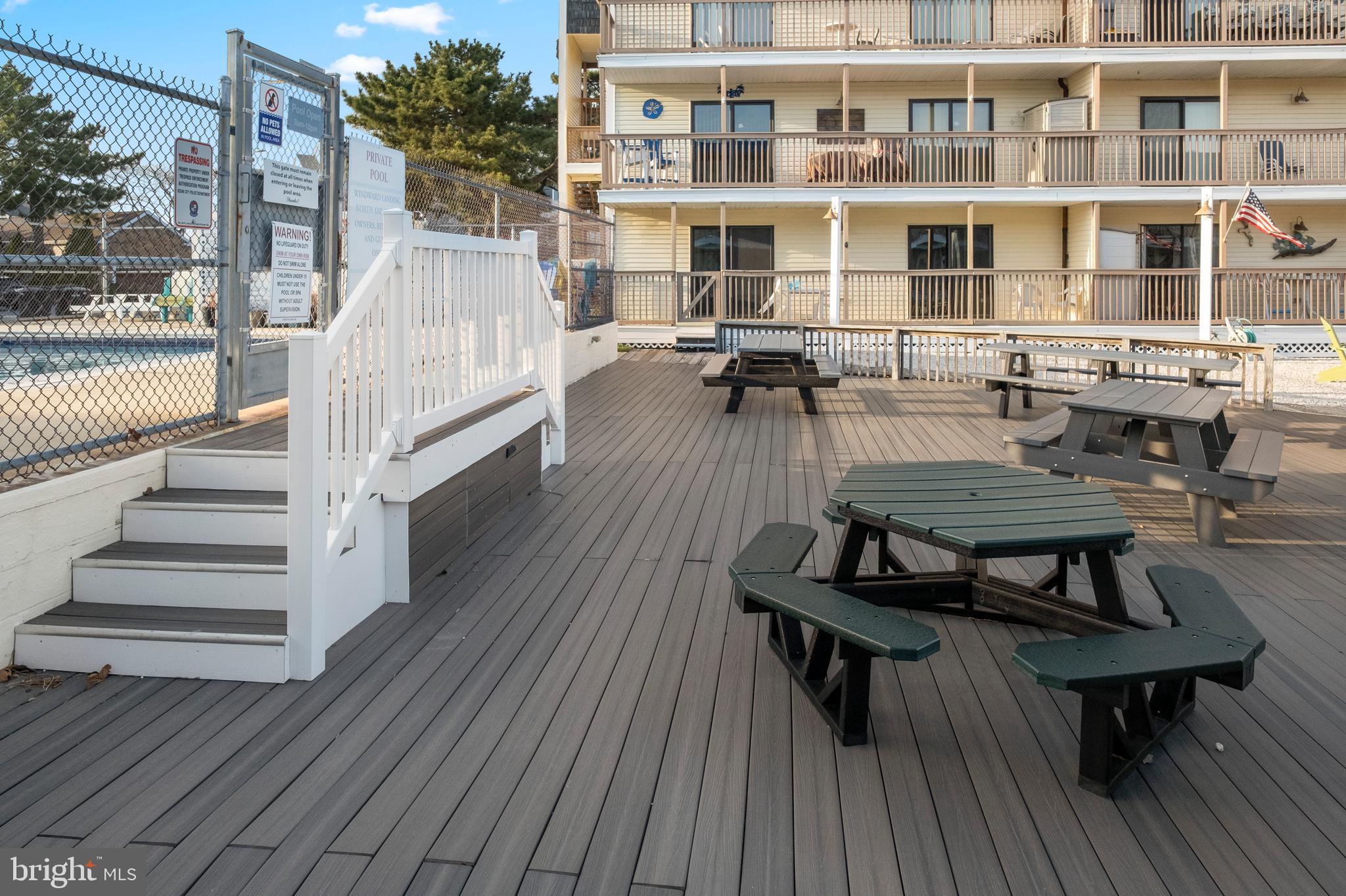 170 Captains Quarters Road, Unit 201 Ocean City, MD 21842 - Photo 56 of 65 a swimming pool with outdoor seating and wooden floor