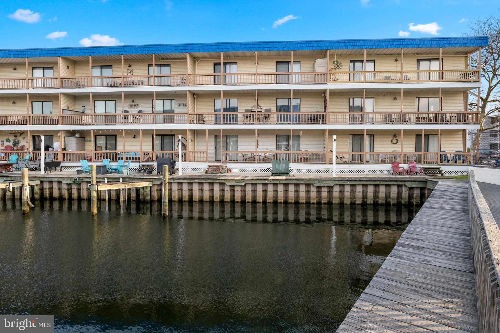 170 Captains Quarters Road, Unit 201 Ocean City, MD 21842 - Photo 57 of 65 a dining room with a table and a book shelf