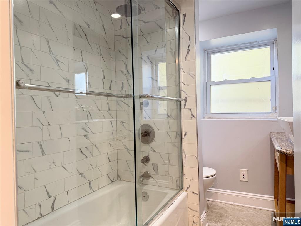227 Washington Avenue Hackensack, NJ 07601 - Photo 12 of 33 a bathroom with a bathtub and a shower