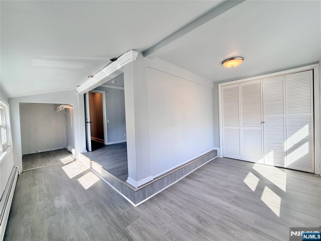 227 Washington Avenue Hackensack, NJ 07601 - Photo 14 of 33 an empty room with wooden floor and windows