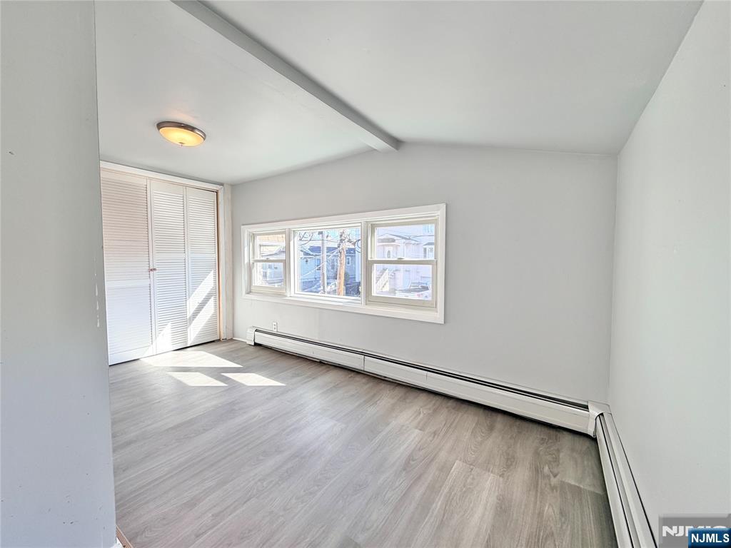 227 Washington Avenue Hackensack, NJ 07601 - Photo 16 of 33 an empty room with wooden floor and windows
