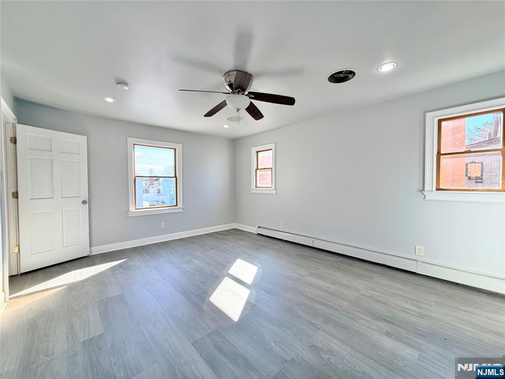 227 Washington Avenue Hackensack, NJ 07601 - Photo 18 of 33 a view of empty room with wooden floor and fan