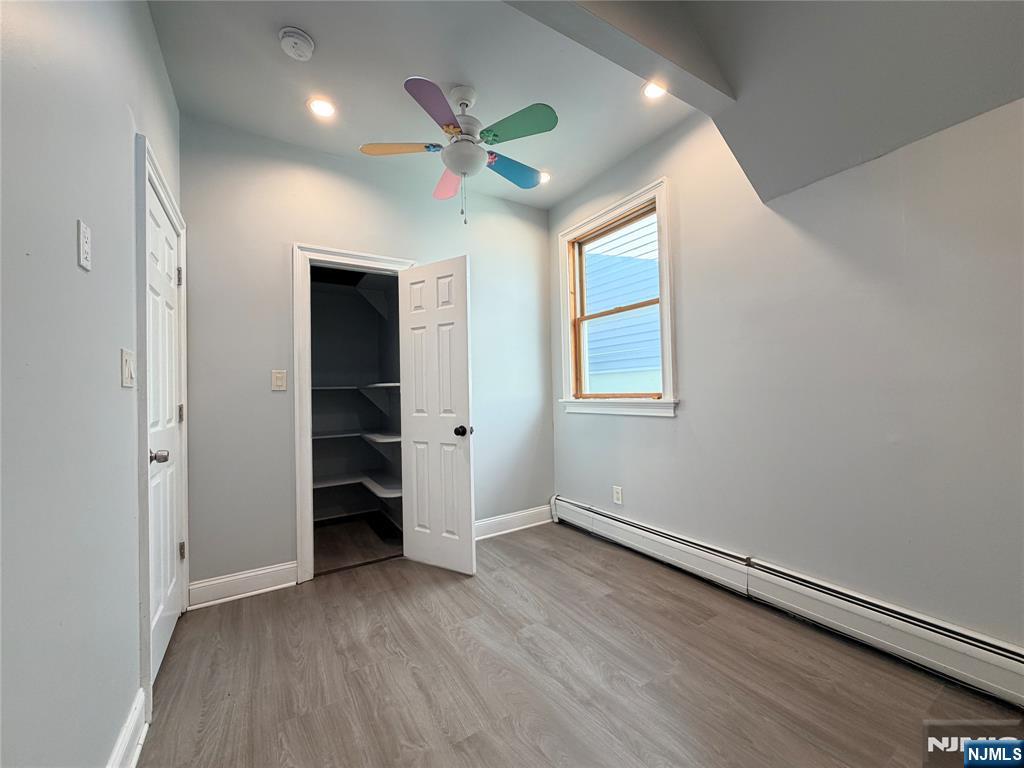 227 Washington Avenue Hackensack, NJ 07601 - Photo 21 of 33 wooden floor in an empty room with a window