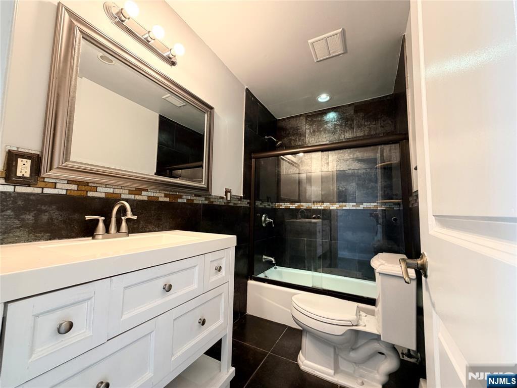 227 Washington Avenue Hackensack, NJ 07601 - Photo 24 of 33 a bathroom with a sink a toilet a mirror and bathtub