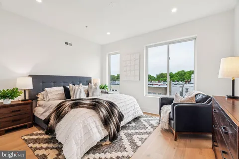 a bedroom with a bed and a couch