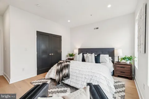 a bedroom with a bed and a couch