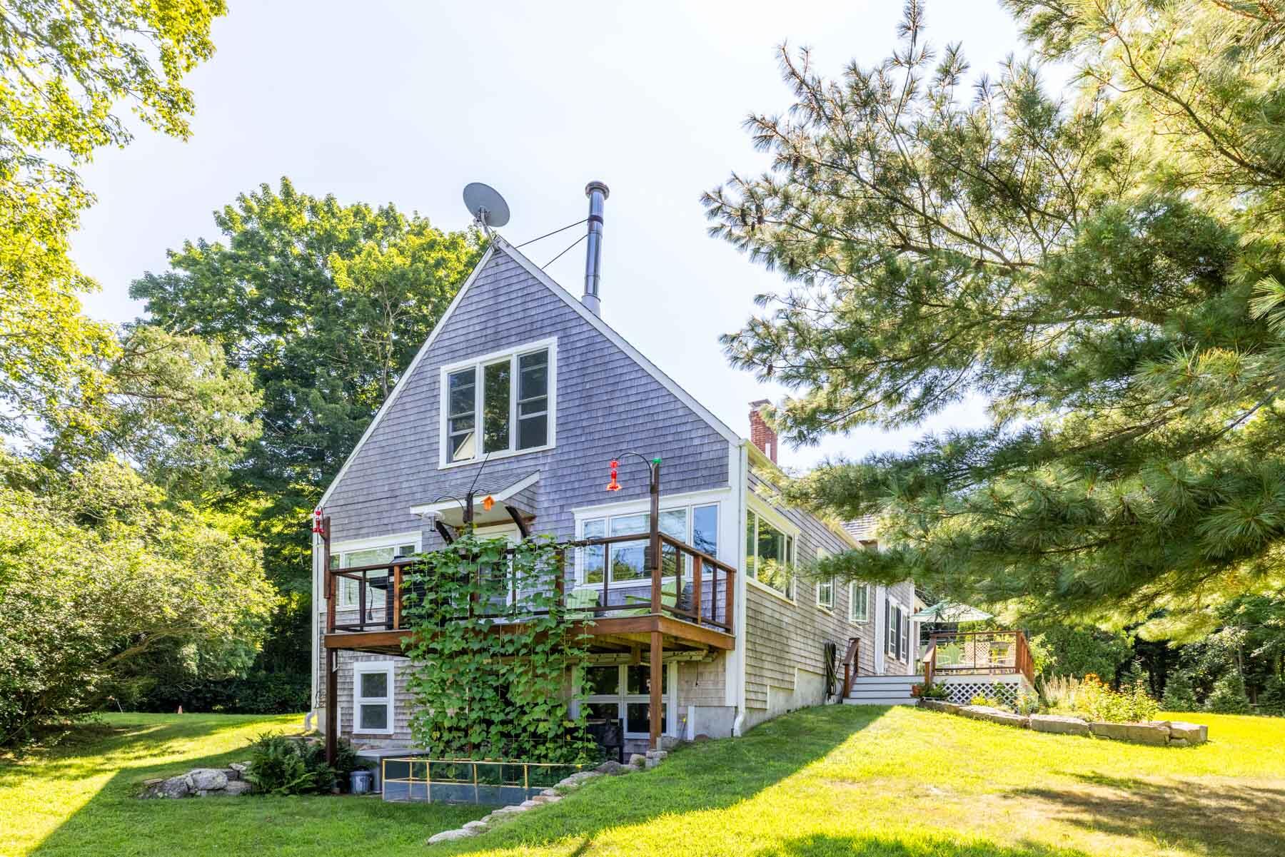 420 Lamberts Cove Road West Tisbury, MA 02568 - Photo 16 of 18 a view of a big yard with plants and large trees