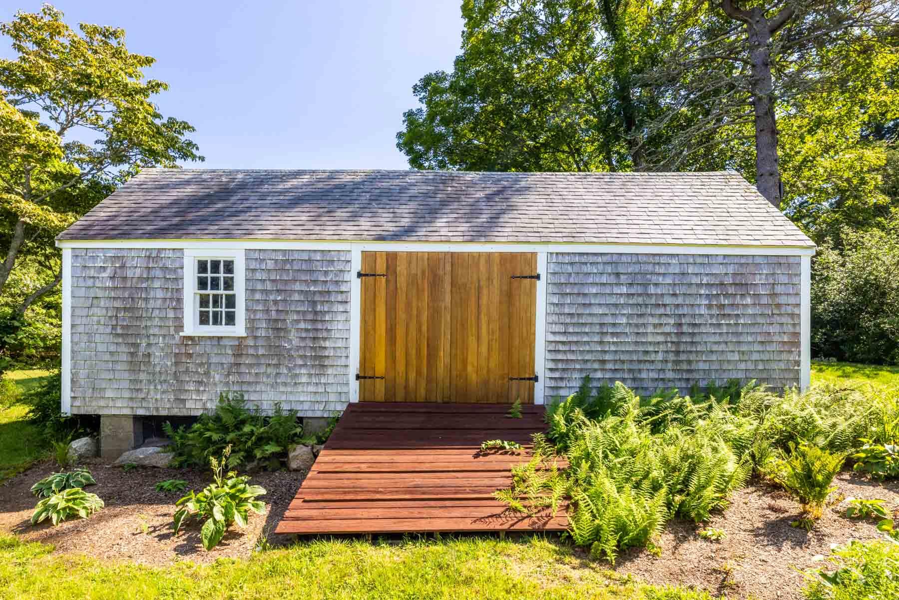 420 Lamberts Cove Road West Tisbury, MA 02568 - Photo 18 of 18 a front view of a house with a yard