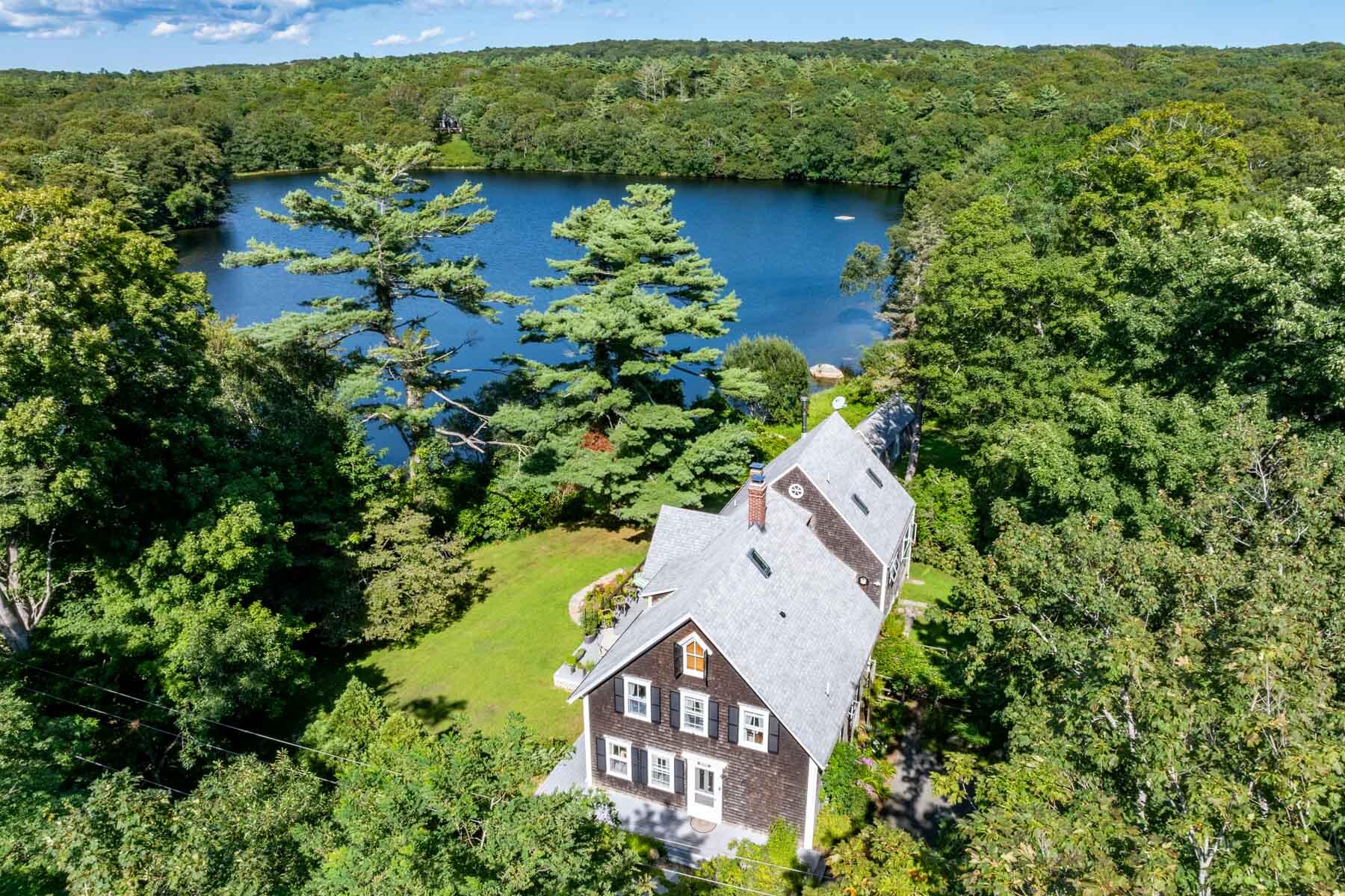 420 Lamberts Cove Road West Tisbury, MA 02568 - Photo 2 of 18 an aerial view of a house with a yard lake and outdoor seating