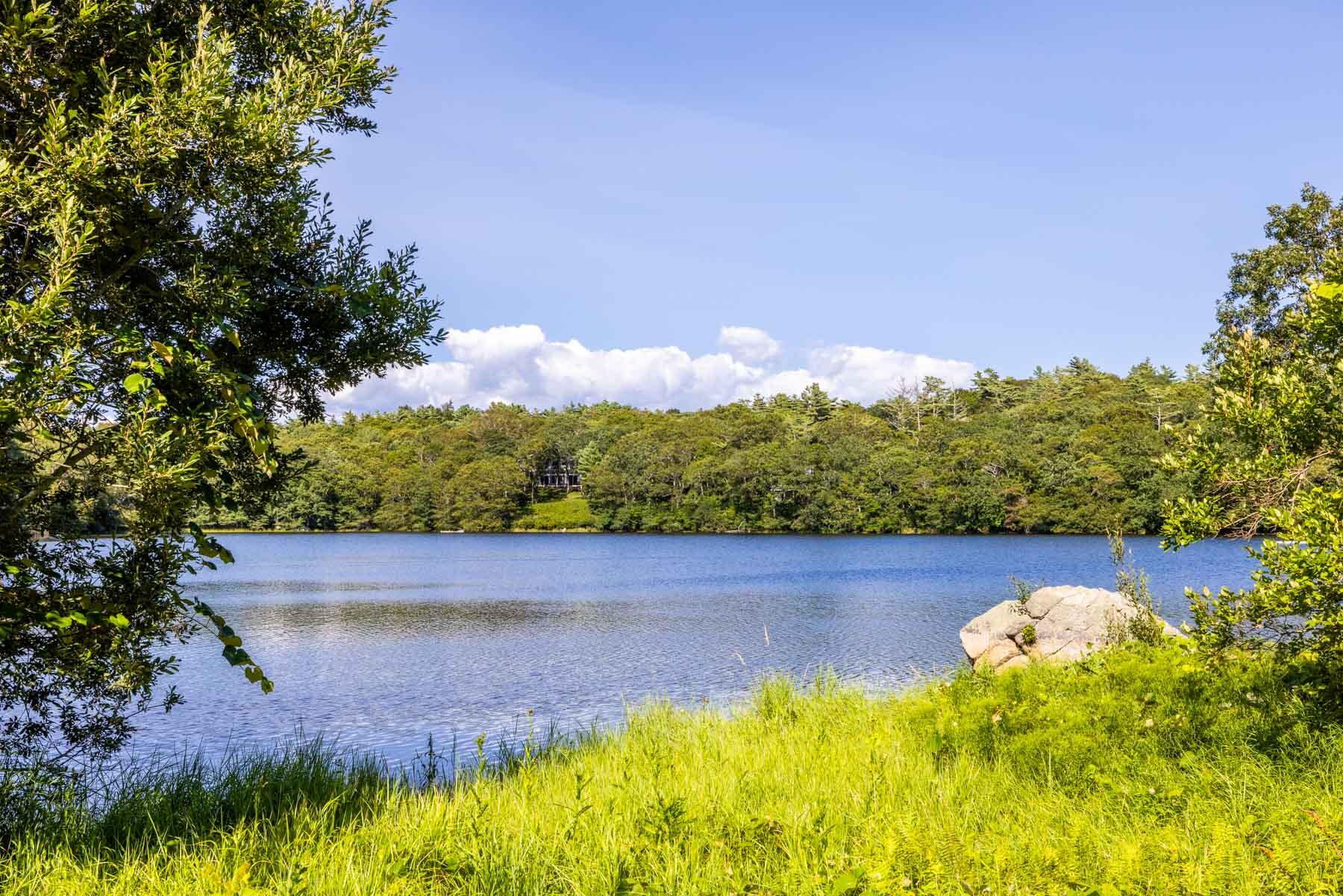 420 Lamberts Cove Road West Tisbury, MA 02568 - Photo 4 of 18 a view of a lake with a yard