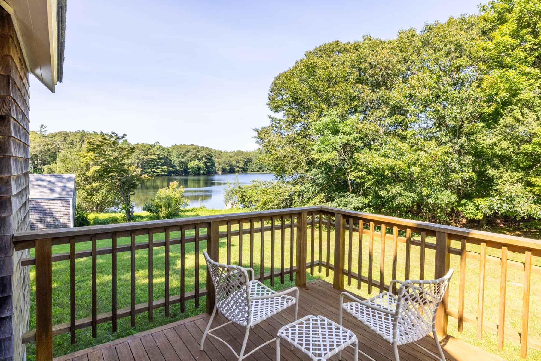 420 Lamberts Cove Road West Tisbury, MA 02568 - Photo 6 of 18 a view of a balcony with wooden floor and fence