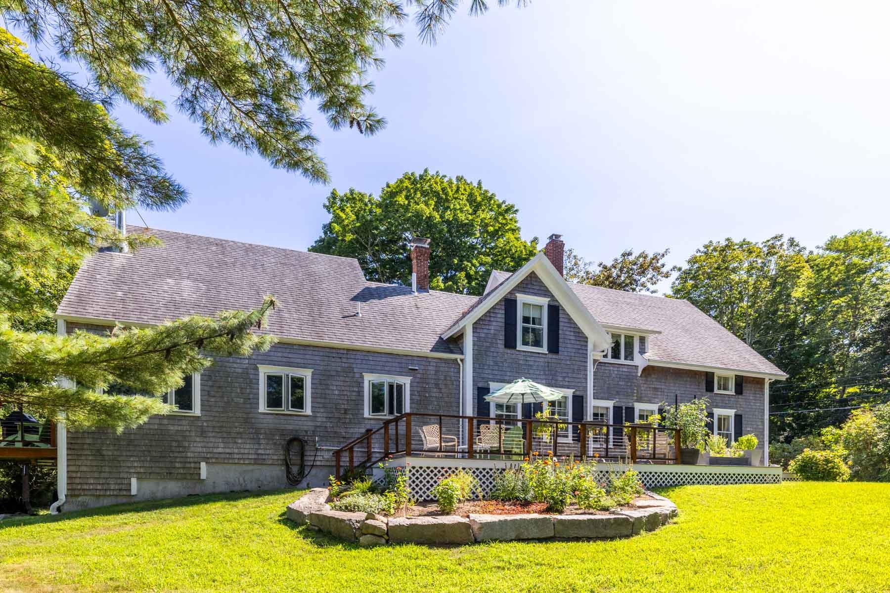 420 Lamberts Cove Road West Tisbury, MA 02568 - Photo 8 of 18 a front view of a house with swimming pool yard and outdoor seating