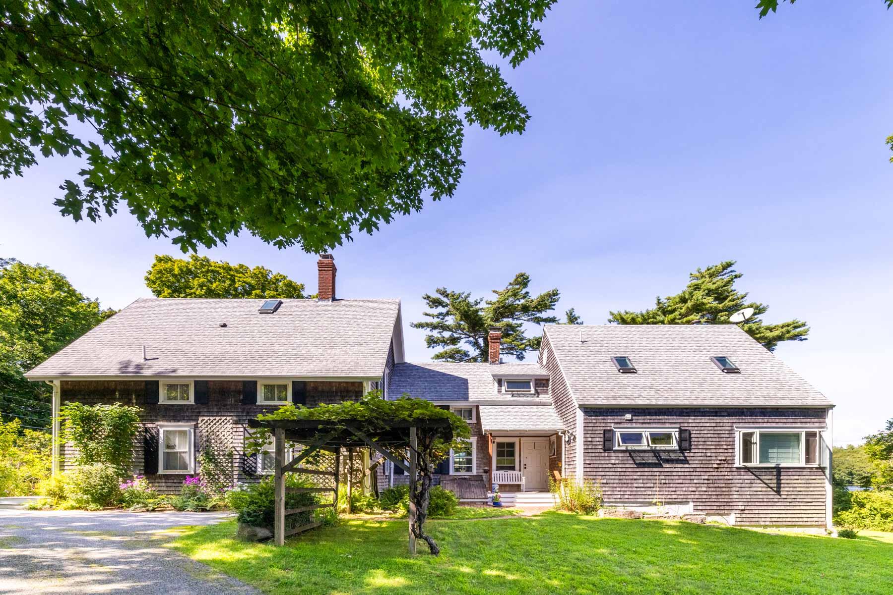 420 Lamberts Cove Road West Tisbury, MA 02568 - Photo 9 of 18 a front view of a house with a garden