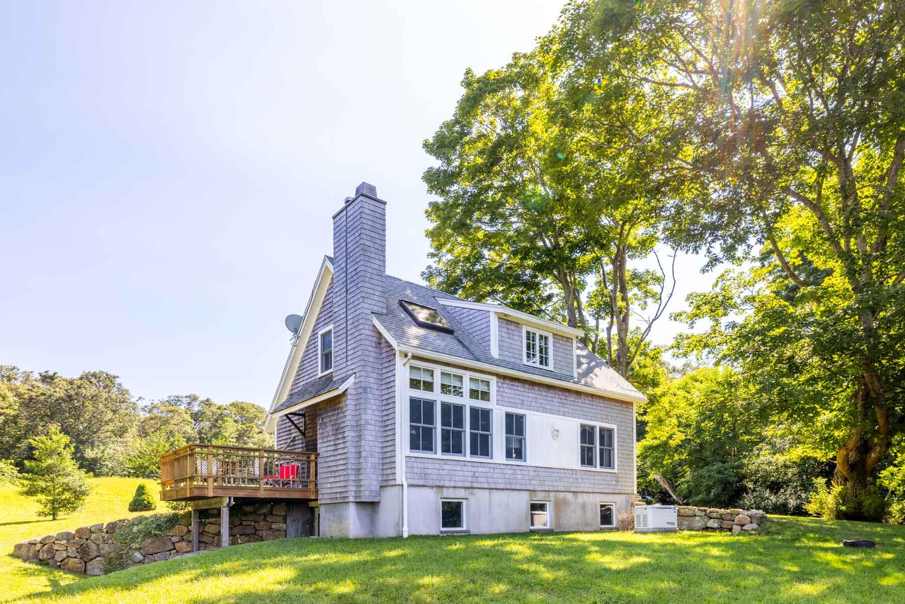 420 Lamberts Cove Road West Tisbury, MA 02568 - Photo 10 of 18 a view of a house with a swimming pool