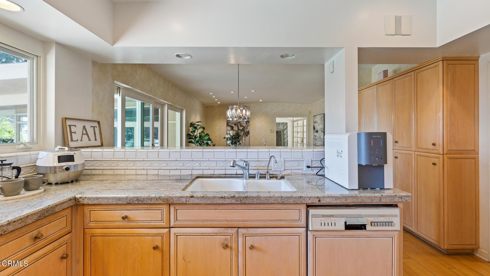 5212 Pizzo Ranch Road La Canada Flintridge, CA 91011 - Photo 12 of 44 a sink with granite countertop a sink and white cabinets