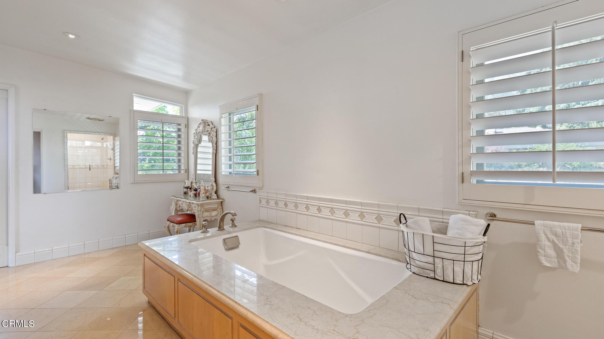 5212 Pizzo Ranch Road La Canada Flintridge, CA 91011 - Photo 19 of 44 a spacious bathroom with a tub a sink and mirror