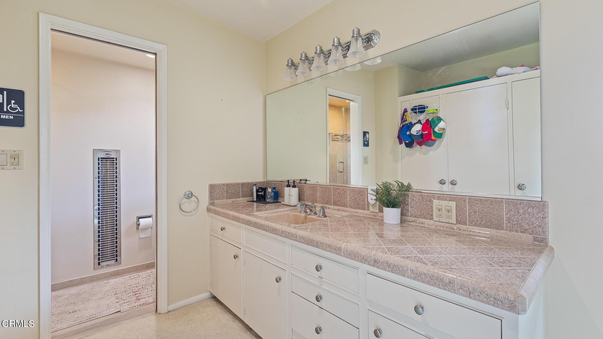 5212 Pizzo Ranch Road La Canada Flintridge, CA 91011 - Photo 25 of 44 a bathroom with a granite countertop double vanity sink and a mirror