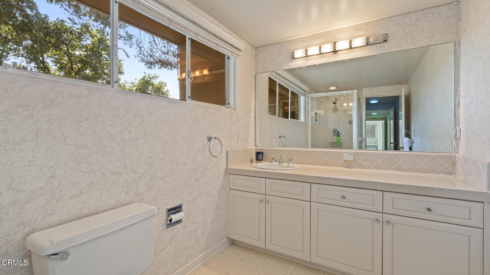 5212 Pizzo Ranch Road La Canada Flintridge, CA 91011 - Photo 28 of 44 a bathroom with a toilet sink and mirror