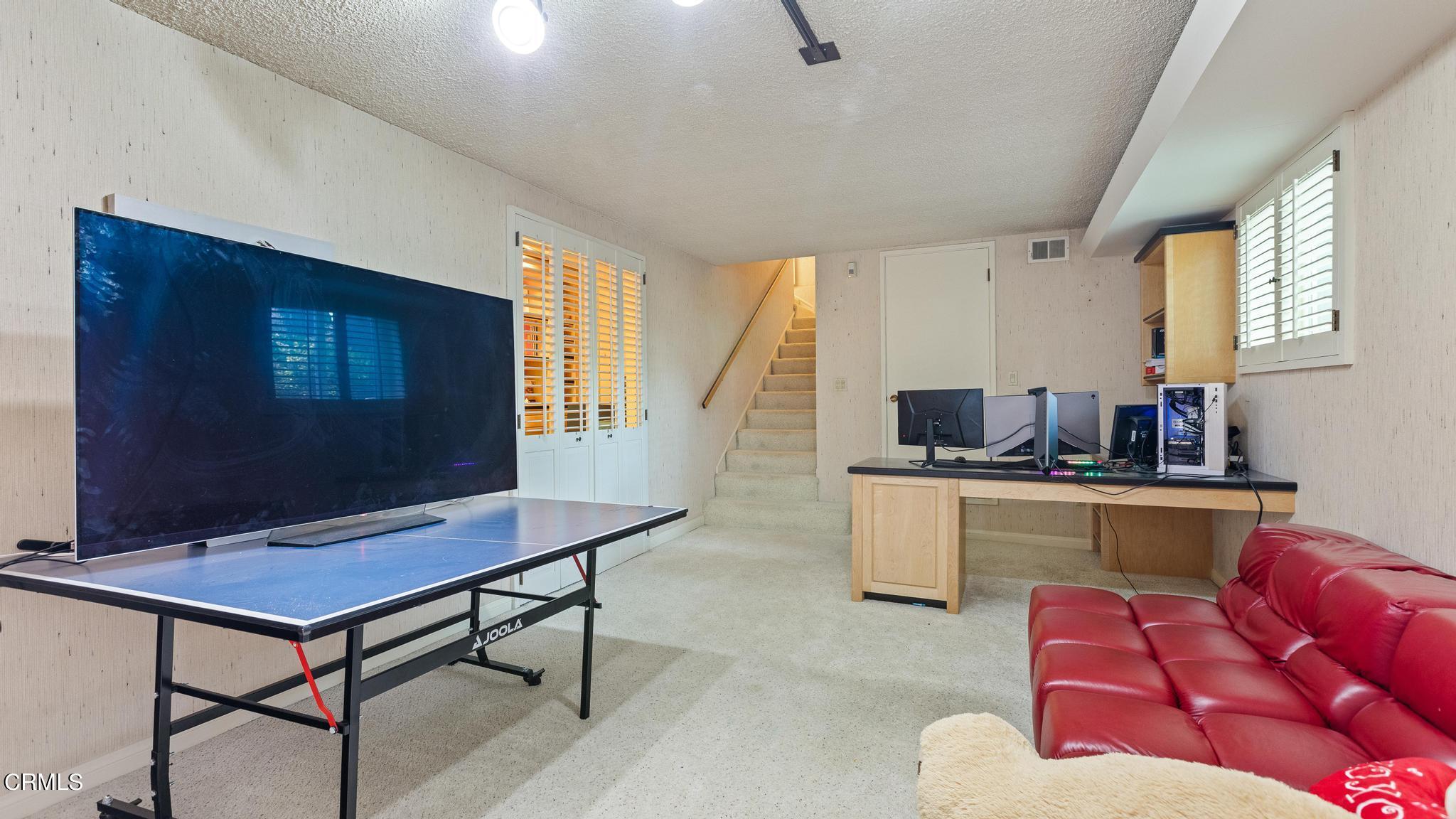5212 Pizzo Ranch Road La Canada Flintridge, CA 91011 - Photo 31 of 44 a living room with furniture and a flat screen tv