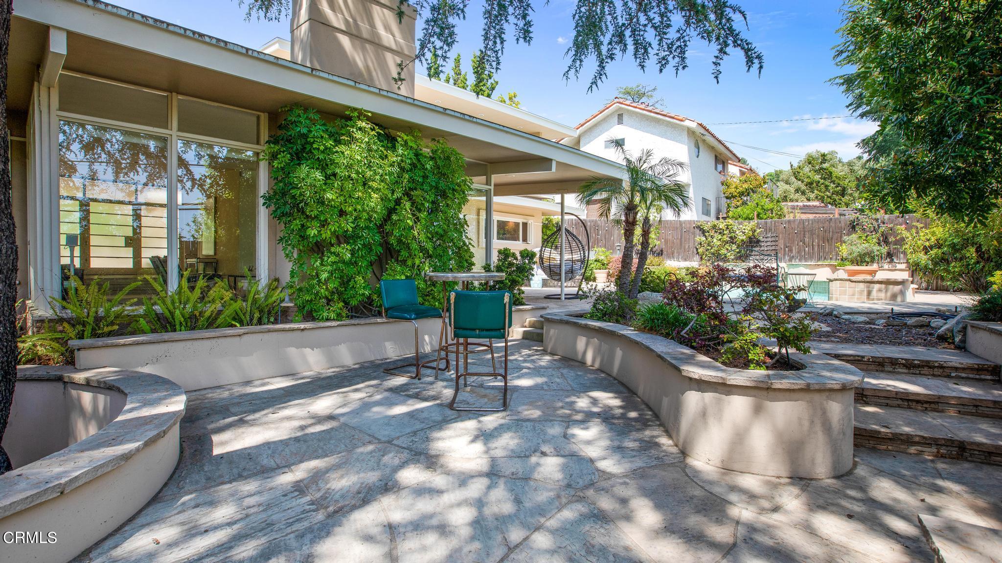 5212 Pizzo Ranch Road La Canada Flintridge, CA 91011 - Photo 38 of 44 a view of a patio with table and chairs potted plants