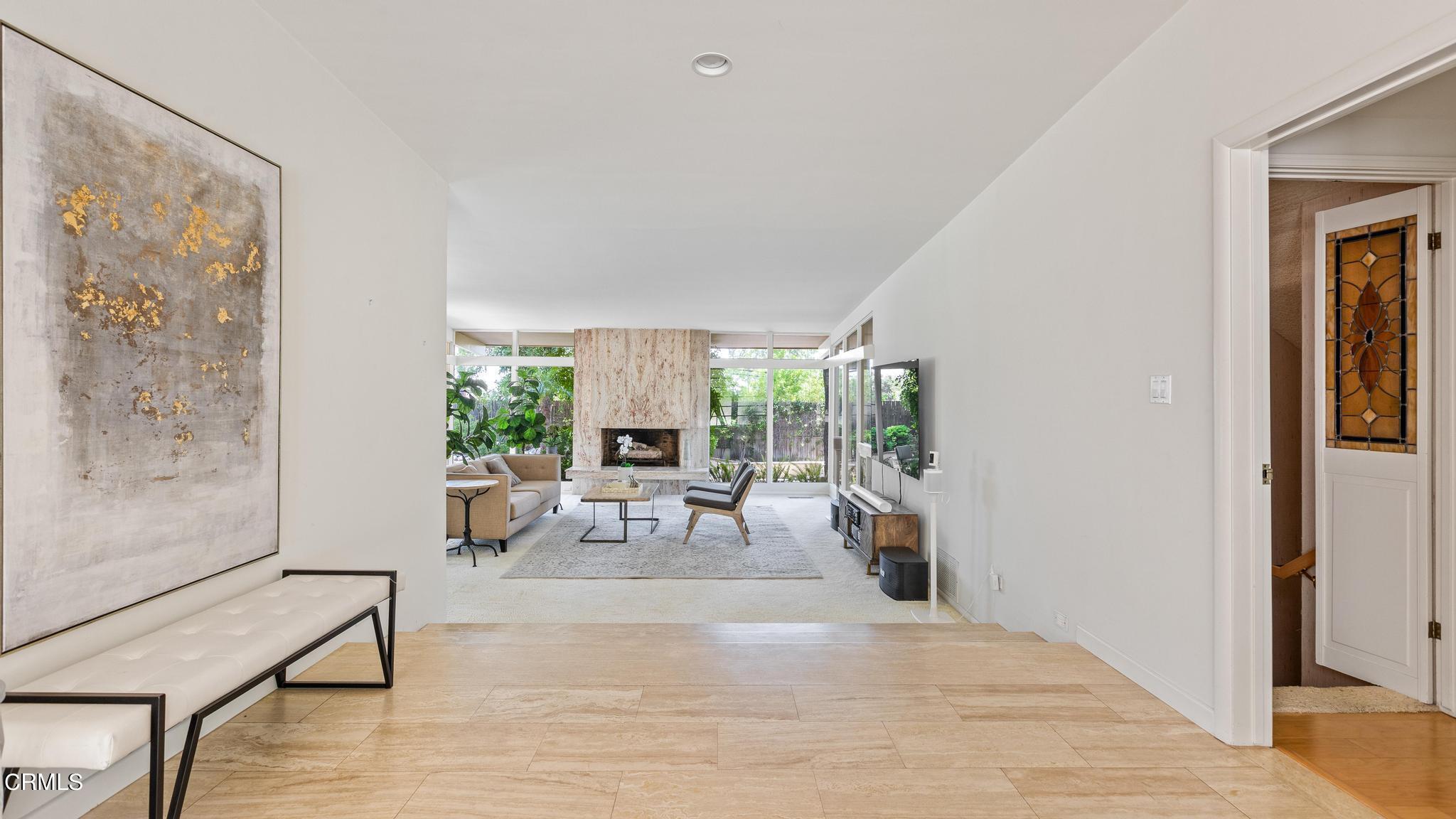 5212 Pizzo Ranch Road La Canada Flintridge, CA 91011 - Photo 4 of 44 a living room with furniture and a fireplace