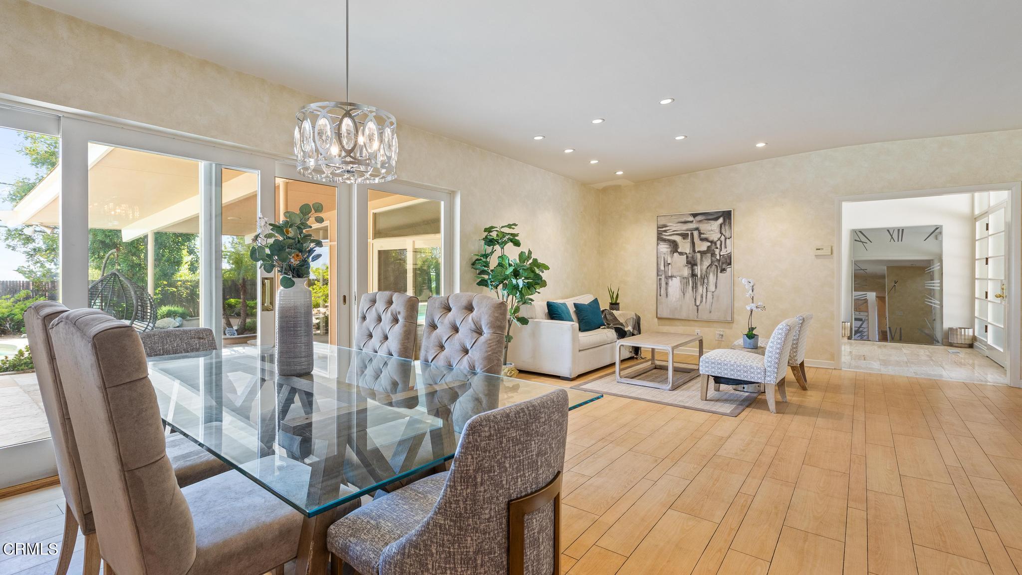 5212 Pizzo Ranch Road La Canada Flintridge, CA 91011 - Photo 10 of 44 a view of a dining room with furniture wooden floor and chandelier