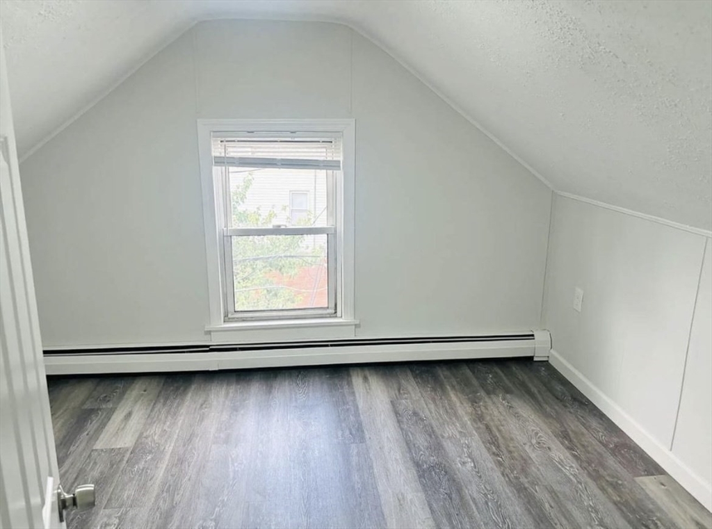 15 Ellsworth Street, Unit 2 Somerville, MA 02145 - Photo 12 of 16 an empty room with wooden floor and a window
