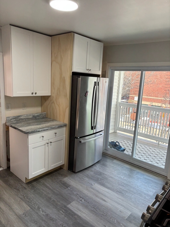 15 Ellsworth Street, Unit 2 Somerville, MA 02145 - Photo 2 of 16 a kitchen with a refrigerator a stove a sink and a window