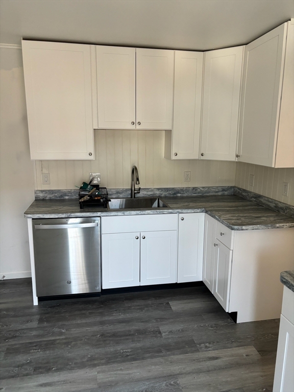 15 Ellsworth Street, Unit 2 Somerville, MA 02145 - Photo 3 of 16 a white kitchen with granite countertop white cabinets and a stove