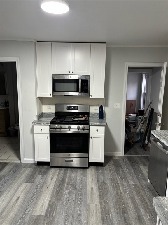 15 Ellsworth Street, Unit 2 Somerville, MA 02145 - Photo 4 of 16 a kitchen with a stove and a microwave