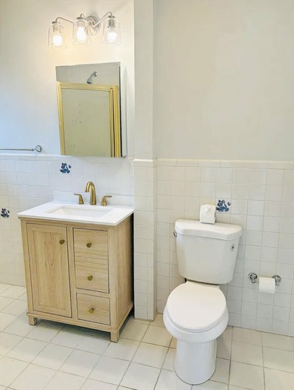 15 Ellsworth Street, Unit 2 Somerville, MA 02145 - Photo 5 of 16 a bathroom with a toilet sink and mirror