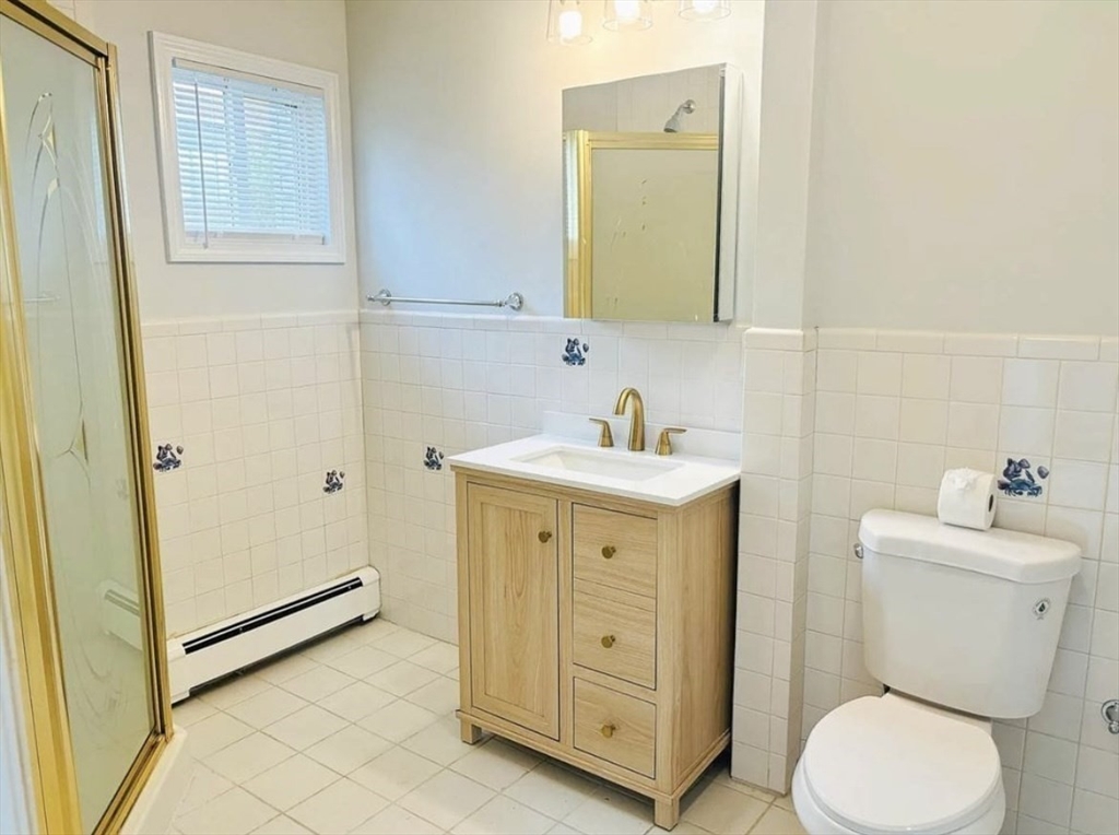 15 Ellsworth Street, Unit 2 Somerville, MA 02145 - Photo 6 of 16 a bathroom with a toilet sink and mirror