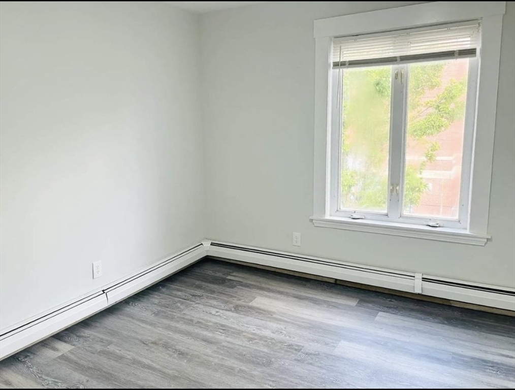 15 Ellsworth Street, Unit 2 Somerville, MA 02145 - Photo 7 of 16 an empty room with a window