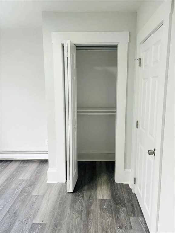 15 Ellsworth Street, Unit 2 Somerville, MA 02145 - Photo 9 of 16 a view of a room with wooden floor and a door