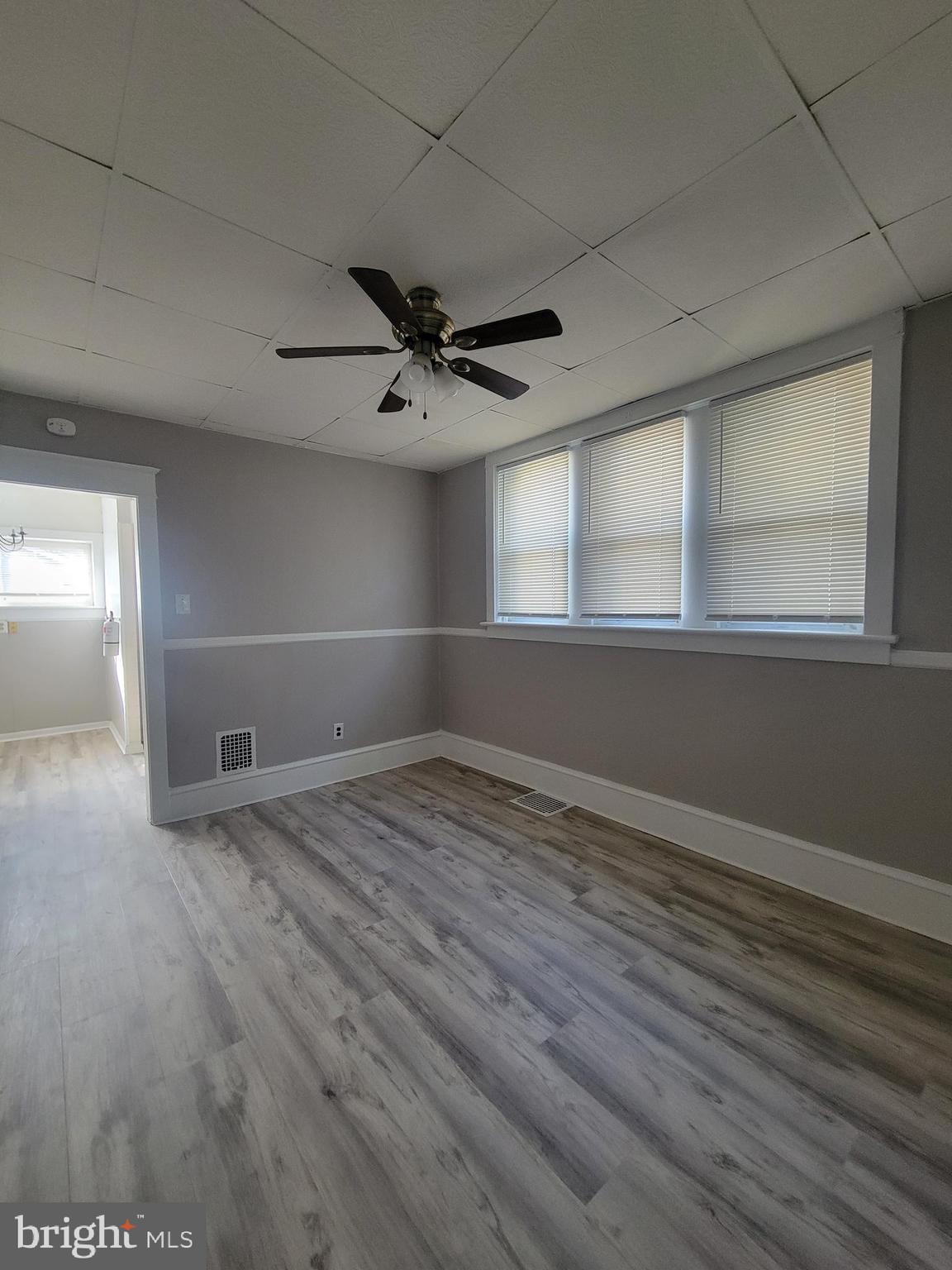 602 Powell Street Gloucester City, NJ 08030 - Photo 6 of 12 an empty room with wooden floor and windows