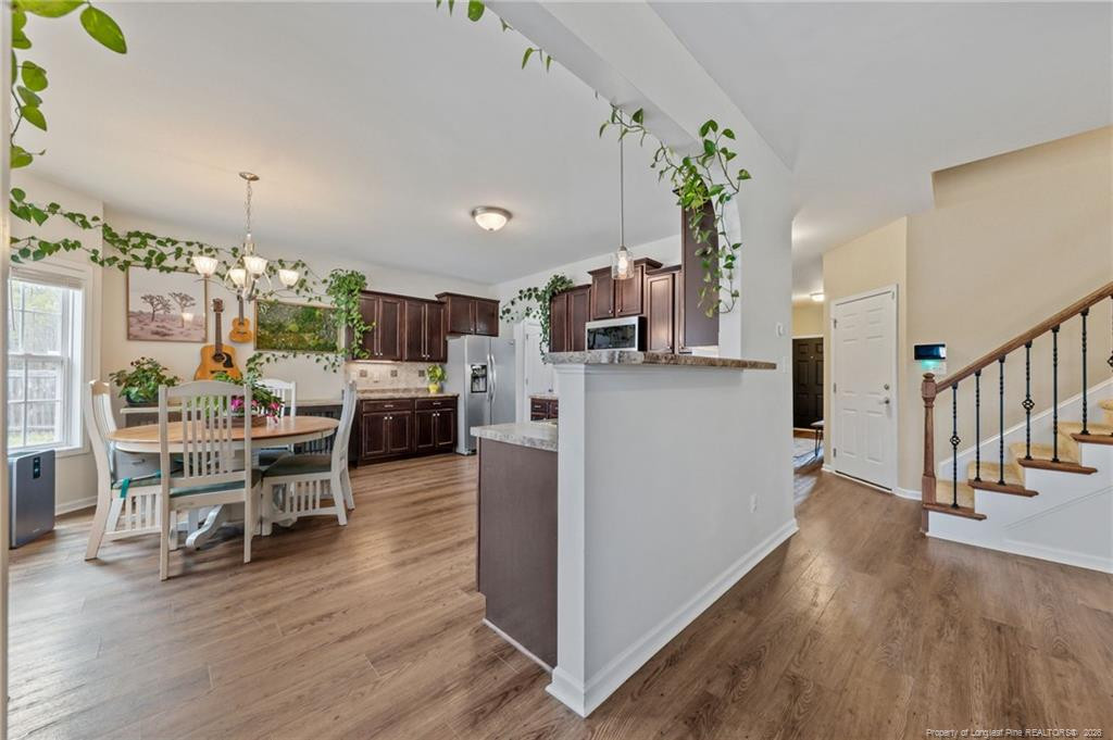 594 Allegiance Street Raeford, NC 28376 - Photo 13 of 49 a view of a dining room with furniture and wooden floor