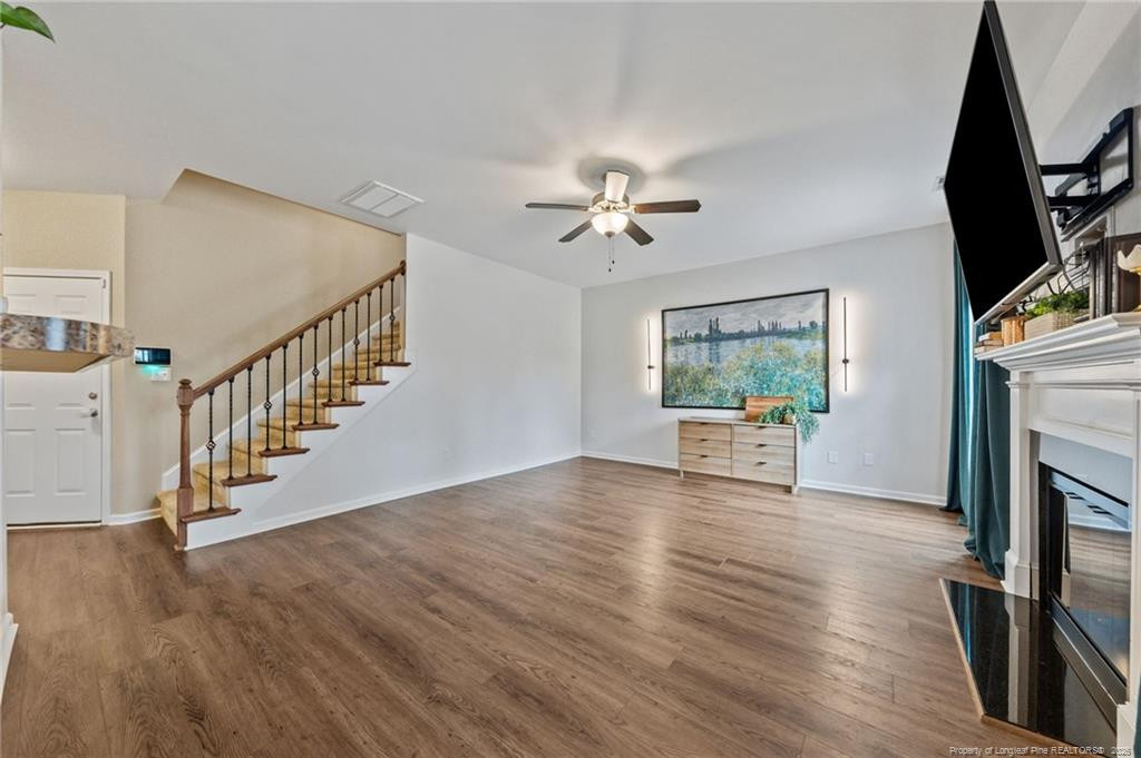 594 Allegiance Street Raeford, NC 28376 - Photo 14 of 49 a view of an empty room with wooden floor and a fireplace