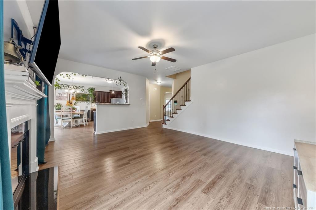 594 Allegiance Street Raeford, NC 28376 - Photo 15 of 49 wooden floor in an empty room with a fireplace