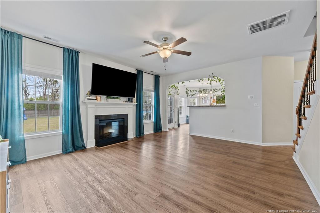 594 Allegiance Street Raeford, NC 28376 - Photo 16 of 49 a view of a livingroom with a flat screen tv ceiling fan and a fireplace