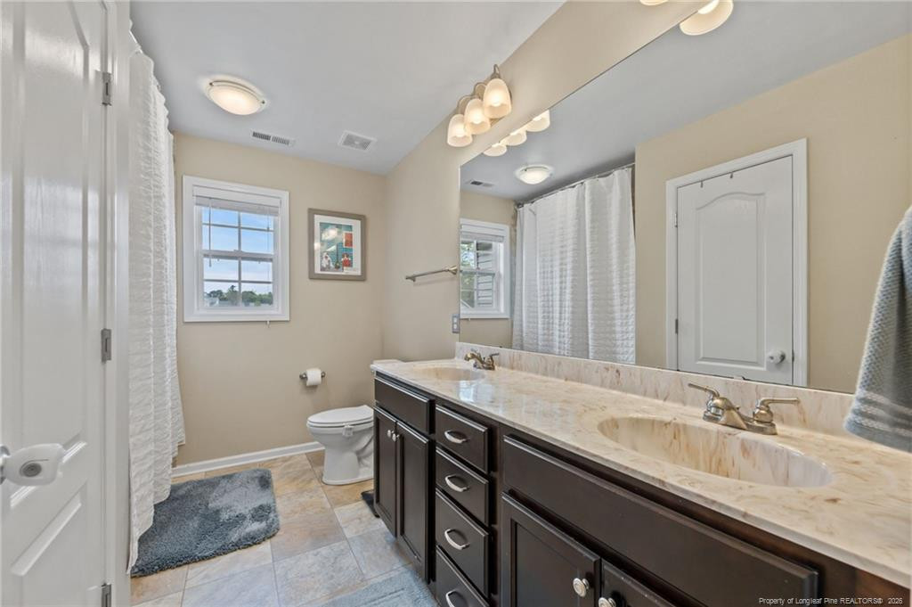 594 Allegiance Street Raeford, NC 28376 - Photo 19 of 49 a bath room with a sink and a mirror