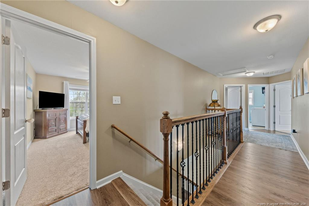 594 Allegiance Street Raeford, NC 28376 - Photo 20 of 49 a view of a hallway to a livingroom with wooden floor and windows