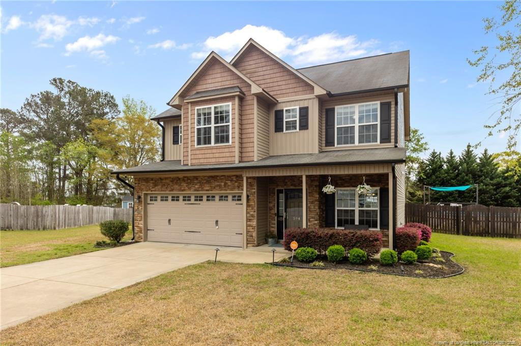 594 Allegiance Street Raeford, NC 28376 - Photo 2 of 49 a front view of a house with a yard and garage