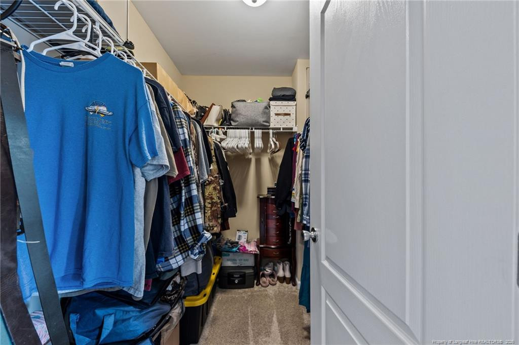 594 Allegiance Street Raeford, NC 28376 - Photo 26 of 49 a view of walk in closet with clothes