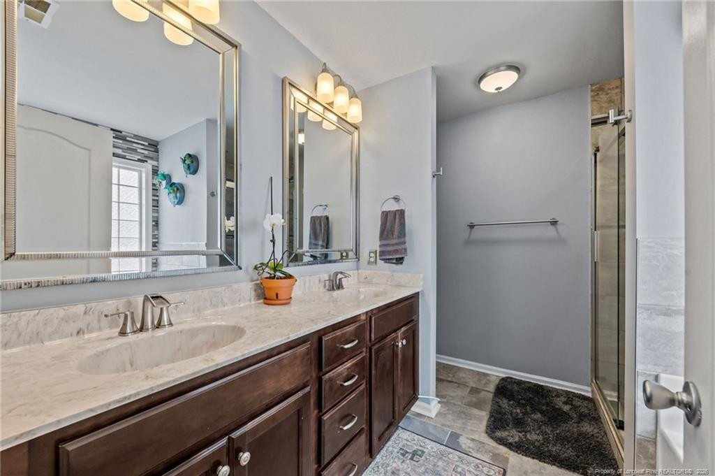 594 Allegiance Street Raeford, NC 28376 - Photo 27 of 49 a bathroom with a sink double vanity and a mirror