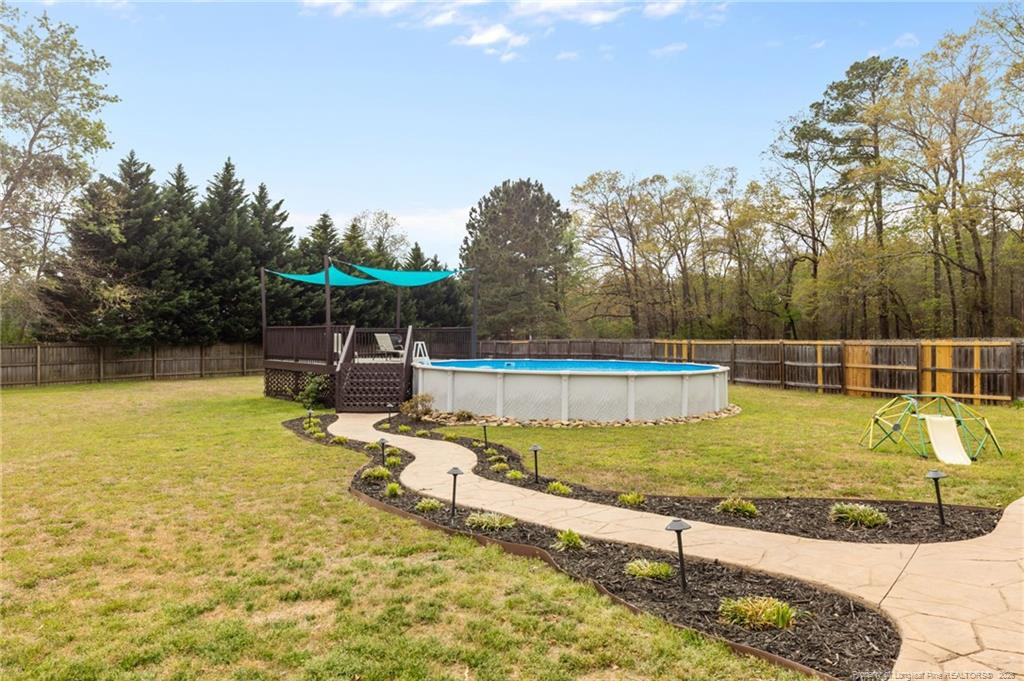 594 Allegiance Street Raeford, NC 28376 - Photo 38 of 49 a view of a swimming pool with an outdoor seating and yard