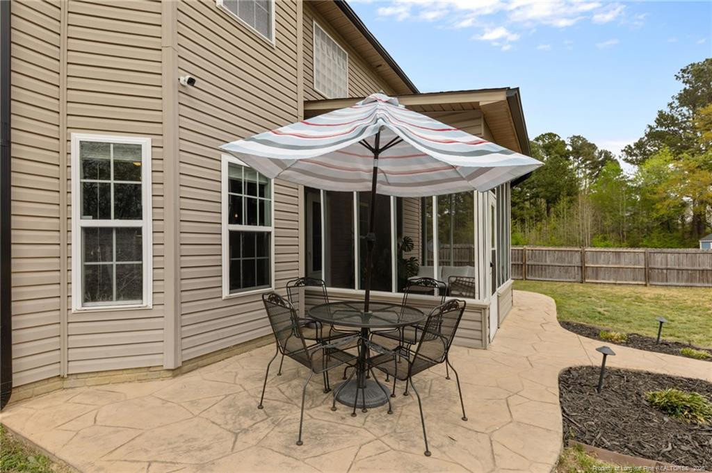 594 Allegiance Street Raeford, NC 28376 - Photo 40 of 49 a view of backyard with seating space and wooden fence