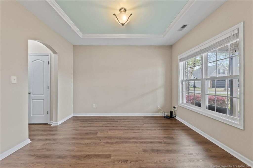 594 Allegiance Street Raeford, NC 28376 - Photo 4 of 49 a view of an empty room with a window and wooden floor